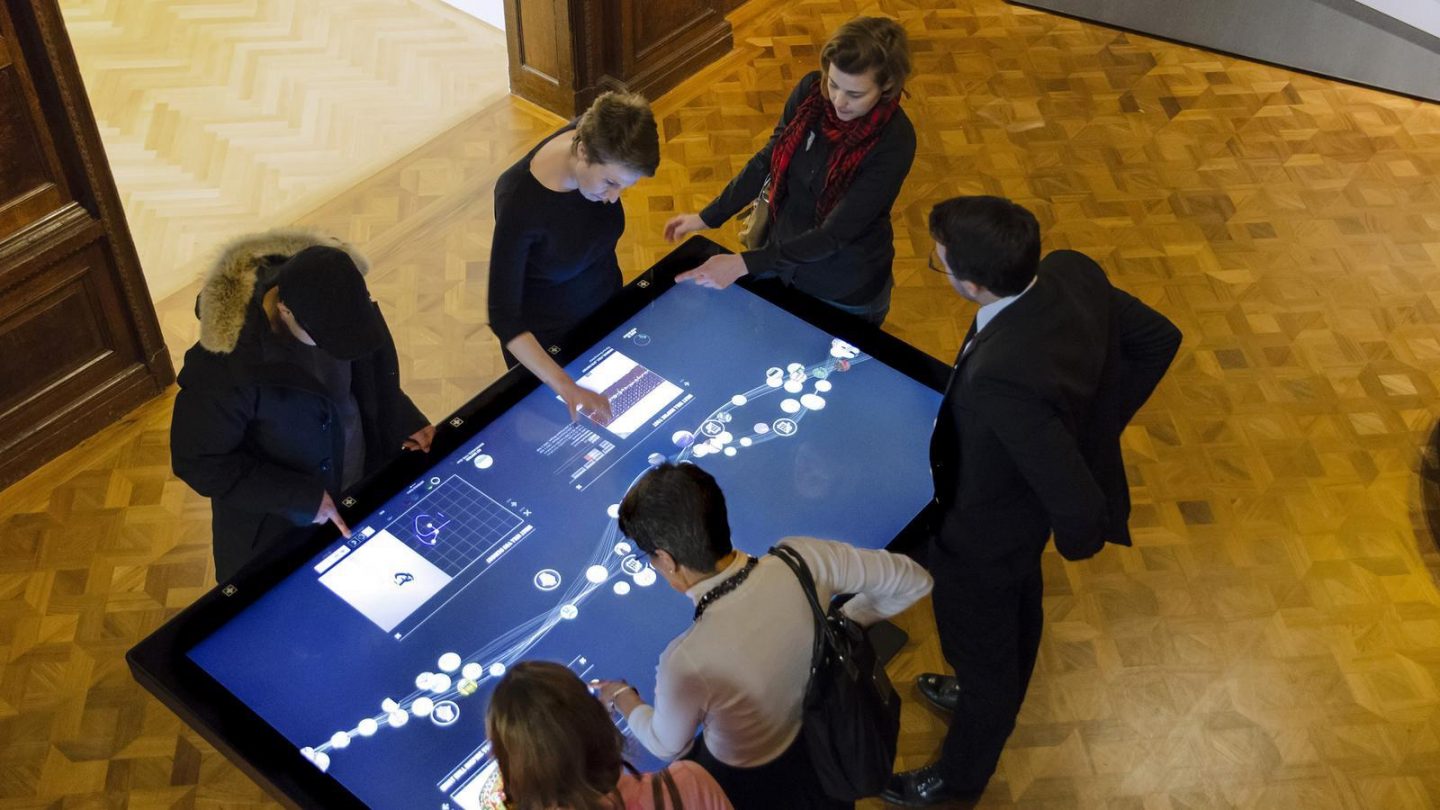 Visitors explore Cooper Hewitt’s collection together on a large interactive table