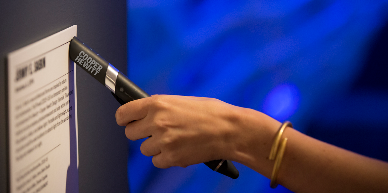 The Cooper Hewitt Pen touching an NFC-enabled gallery label